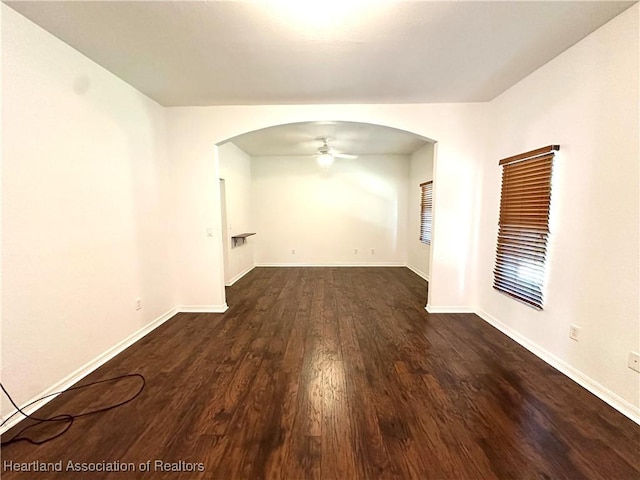 empty room featuring ceiling fan and dark hardwood / wood-style flooring