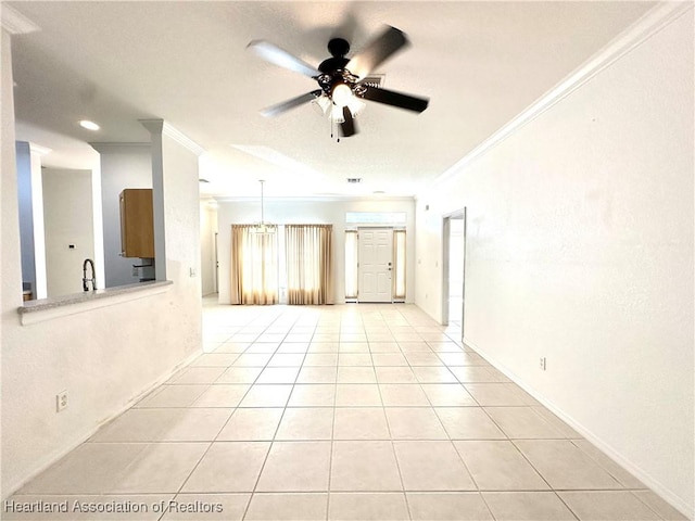 tiled spare room with crown molding and ceiling fan with notable chandelier