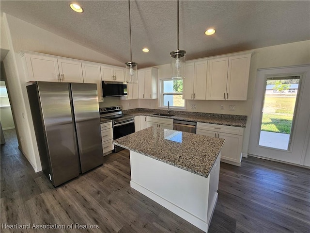 2859 N Lancaster Rd, Avon Park, FL 33825 - kitchen featuring a textured ceiling, white cabinetry, a sink, appliances with stainless steel finishes, and dark wood-style flooring