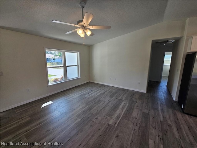 2859 N Lancaster Rd, Avon Park, FL 33825 - empty room featuring baseboards, a ceiling fan, a textured ceiling, and dark wood-style flooring