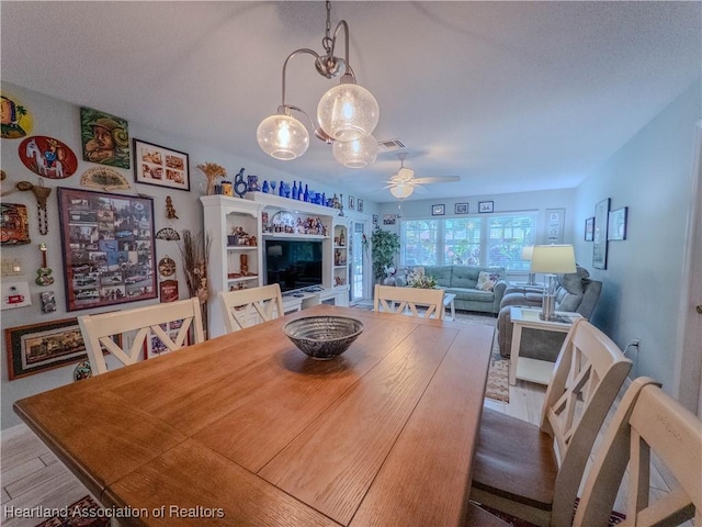 dining space with visible vents and a ceiling fan