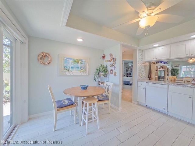dining area featuring baseboards, recessed lighting, a ceiling fan, and a tray ceiling