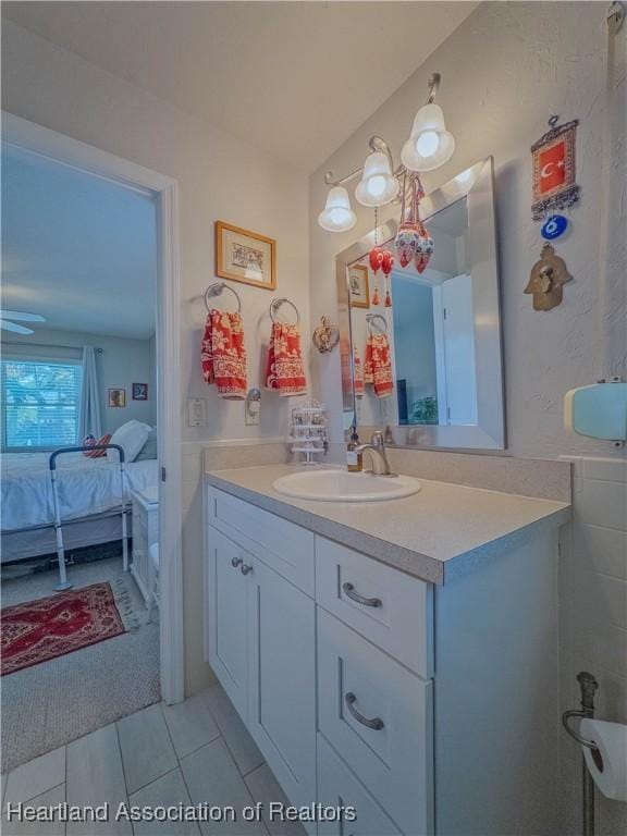 bathroom with tile patterned flooring, ensuite bathroom, and vanity