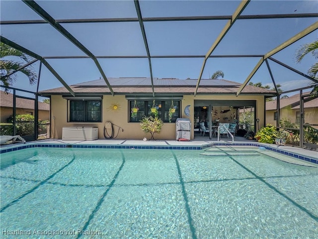pool with a lanai and a patio area