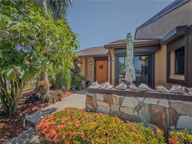 entrance to property with stucco siding