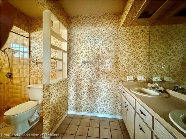 full bathroom with tile patterned flooring, a sink, baseboards, and tiled shower