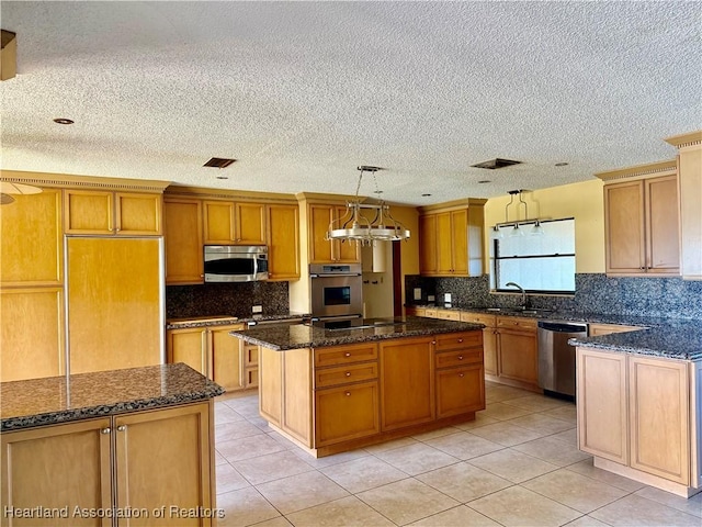kitchen with decorative backsplash, light tile patterned flooring, a kitchen island, and stainless steel appliances