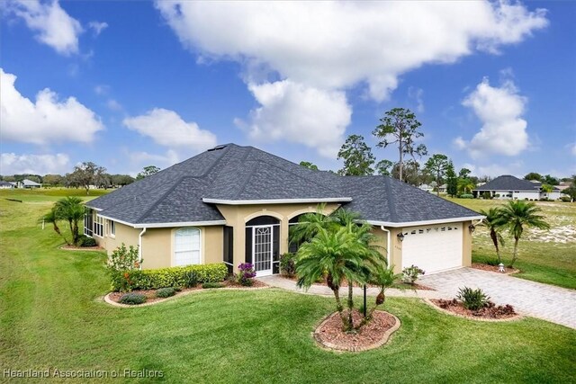 ranch-style home with a garage and a front lawn