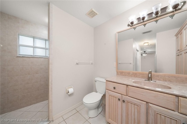 bathroom featuring a walk in shower, tile patterned floors, toilet, ceiling fan, and vanity