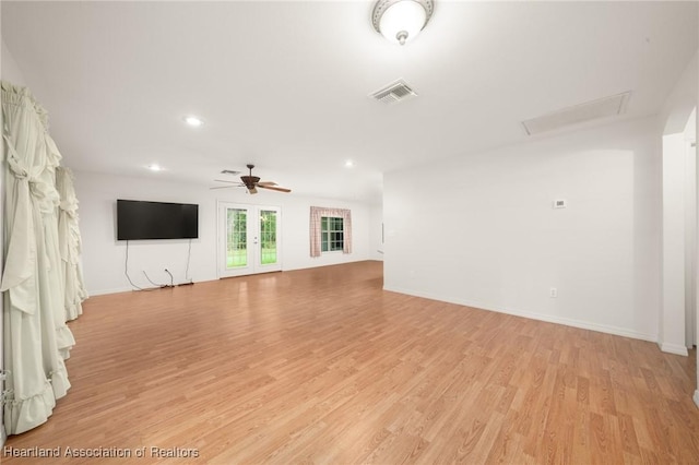 unfurnished living room with light wood-type flooring, ceiling fan, recessed lighting, baseboards, and attic access