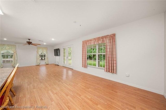 unfurnished living room featuring light wood-style flooring, ceiling fan, recessed lighting, and baseboards