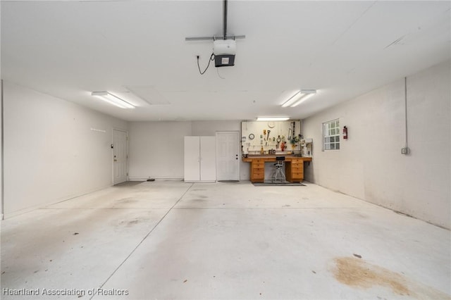 garage featuring a workshop area and a garage door opener