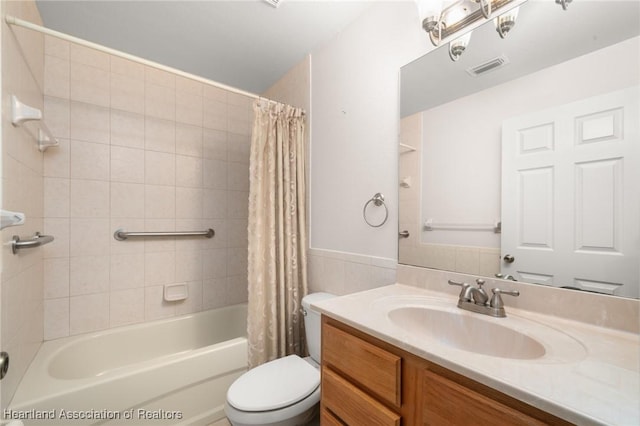 bathroom featuring toilet, vanity, and shower / bath combo