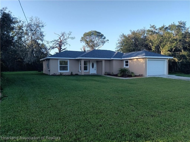 single story home featuring a front lawn and a garage