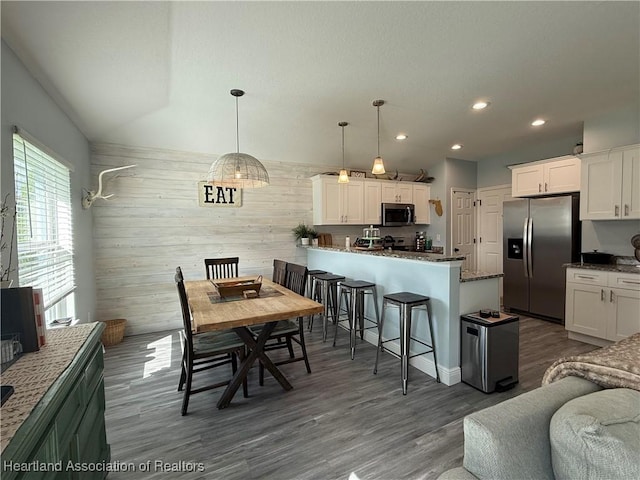 424 Branbury Ave, Lake Placid, FL 33852 - dining area with dark wood finished floors, recessed lighting, and wood walls
