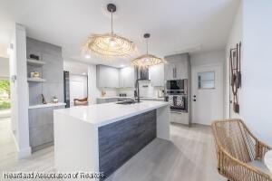 11200 S Jefferson Ave, Lake Placid, FL 33852 - kitchen with gray cabinets, light countertops, double oven, and modern cabinets