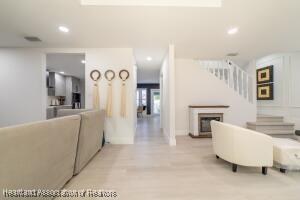 11200 S Jefferson Ave, Lake Placid, FL 33852 - living room with recessed lighting, stairs, wood finished floors, and a fireplace