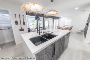 11200 S Jefferson Ave, Lake Placid, FL 33852 - kitchen with light countertops, a kitchen island with sink, decorative light fixtures, modern cabinets, and a sink