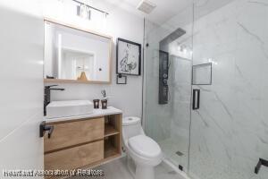 11200 S Jefferson Ave, Lake Placid, FL 33852 - bathroom featuring toilet, a marble finish shower, and vanity