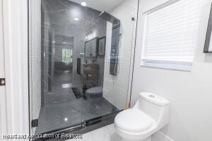 11200 S Jefferson Ave, Lake Placid, FL 33852 - bathroom with toilet and a shower stall
