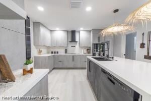 11200 S Jefferson Ave, Lake Placid, FL 33852 - kitchen featuring gray cabinets, wall chimney range hood, light countertops, dishwasher, and a sink