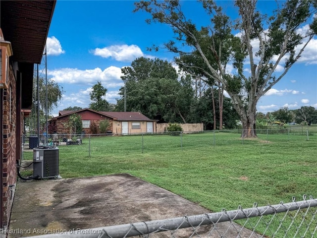 view of yard featuring a patio and central AC unit
