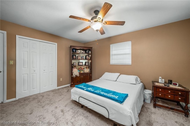 carpeted bedroom with a closet and ceiling fan
