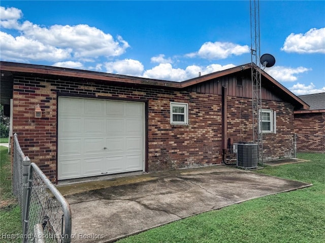 exterior space with a garage and cooling unit