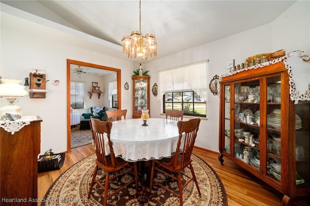 dining space with a chandelier and light wood-type flooring