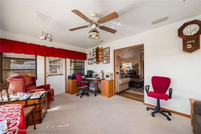 carpeted office with ceiling fan