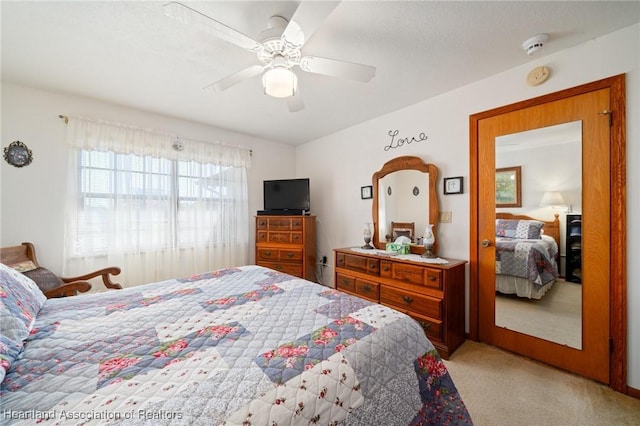 carpeted bedroom featuring ceiling fan