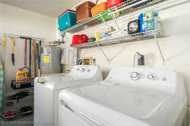 clothes washing area featuring washing machine and dryer and water heater