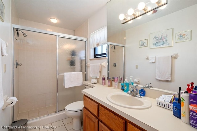 bathroom featuring vanity, toilet, tile patterned floors, and walk in shower