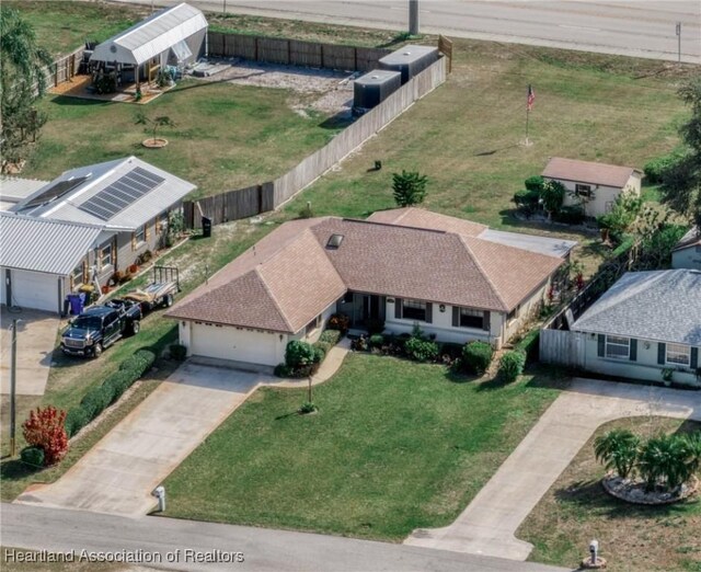 single story home featuring a garage and a front yard