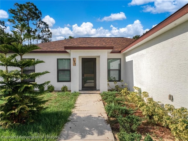 111 Blue Moon Ave, Lake Placid, FL 33852 - property entrance featuring stucco siding and a shingled roof