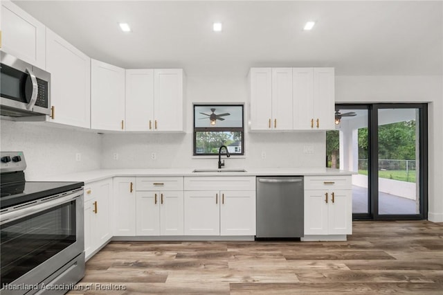 111 Blue Moon Ave, Lake Placid, FL 33852 - kitchen featuring stainless steel appliances, a sink, light countertops, healthy amount of natural light, and recessed lighting