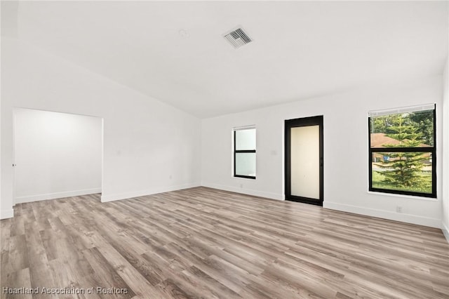 111 Blue Moon Ave, Lake Placid, FL 33852 - empty room featuring light wood-style flooring, baseboards, and lofted ceiling
