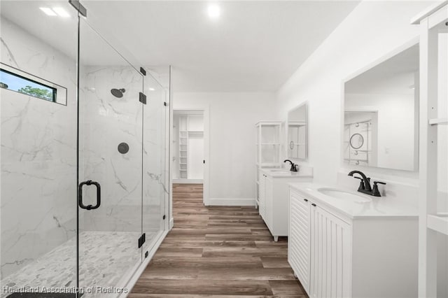 111 Blue Moon Ave, Lake Placid, FL 33852 - bathroom featuring a marble finish shower, wood finished floors, and two vanities