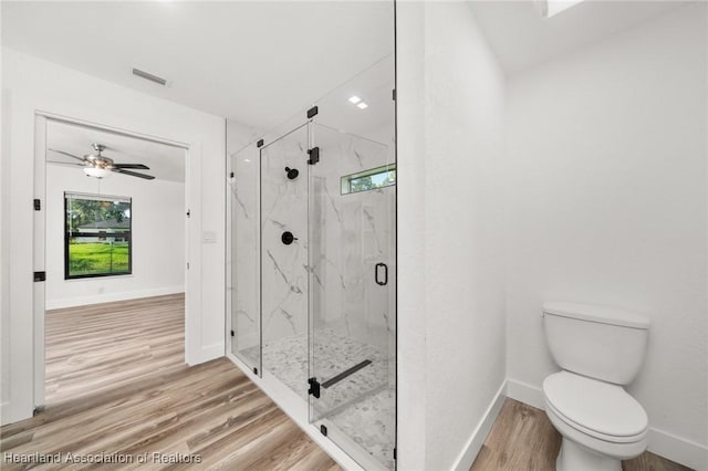 111 Blue Moon Ave, Lake Placid, FL 33852 - bathroom with wood finished floors, toilet, baseboards, and a marble finish shower