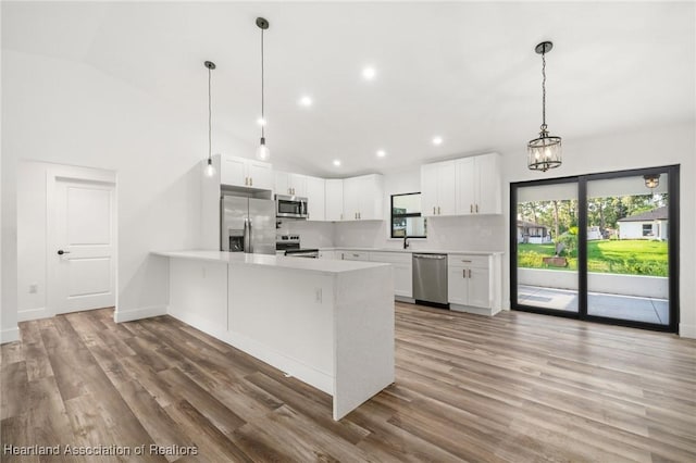 111 Blue Moon Ave, Lake Placid, FL 33852 - kitchen with appliances with stainless steel finishes, plenty of natural light, a peninsula, light countertops, and recessed lighting