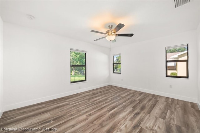 111 Blue Moon Ave, Lake Placid, FL 33852 - unfurnished room with baseboards, wood finished floors, and a ceiling fan