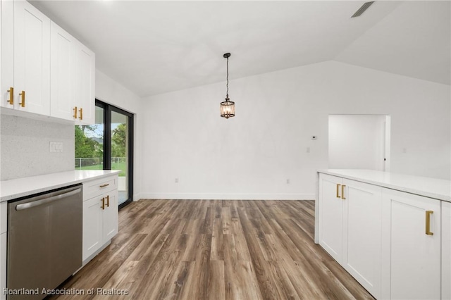111 Blue Moon Ave, Lake Placid, FL 33852 - unfurnished dining area featuring wood finished floors, vaulted ceiling, and baseboards