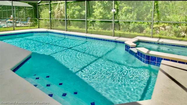 view of swimming pool featuring glass enclosure