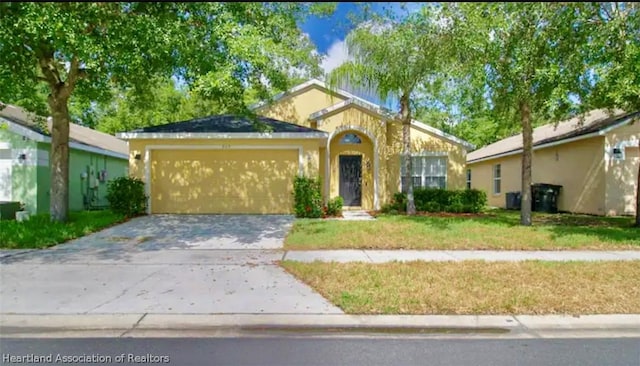 view of front of home with a garage and a front lawn