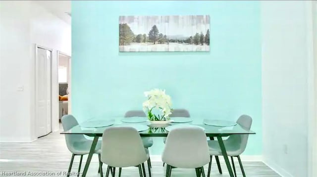 dining space featuring light wood-type flooring