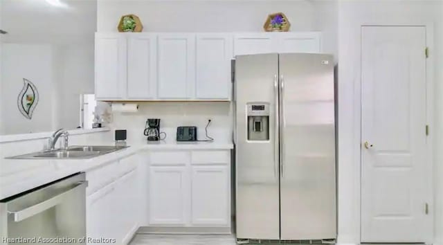 kitchen with white cabinetry, sink, and appliances with stainless steel finishes