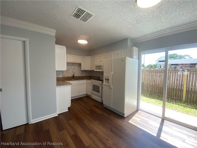 kitchen featuring white appliances, backsplash, white cabinets, sink, and dark hardwood / wood-style flooring