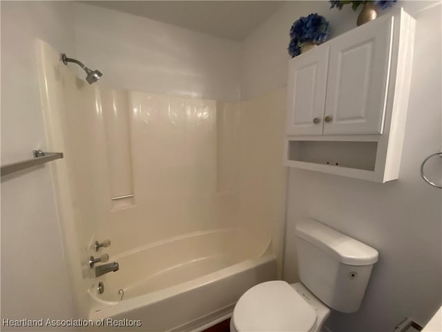 bathroom with bathing tub / shower combination and toilet