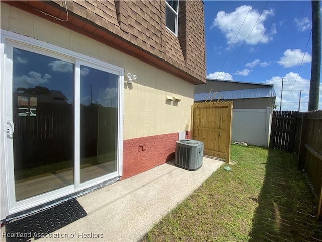 view of side of home with a yard and central AC unit