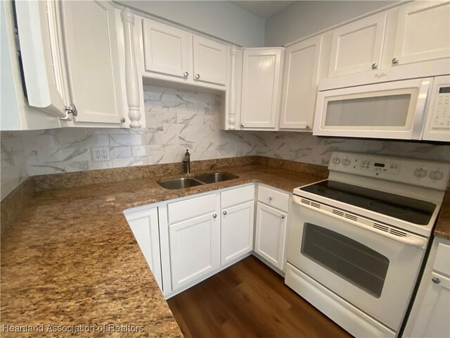 kitchen featuring sink, white appliances, and white cabinets